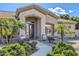 Front entrance with mature landscaping and walkway at 18009 W Denton Ave, Litchfield Park, AZ 85340