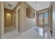 Inviting foyer with elegant tile flooring, decorative wall accents, and a stylish front door at 18009 W Denton Ave, Litchfield Park, AZ 85340