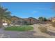 Attractive single-story home featuring desert landscaping with defined lawn area and a clear blue sky at 18009 W Denton Ave, Litchfield Park, AZ 85340