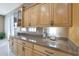 Long kitchen counter with granite countertop and wood cabinets at 18009 W Denton Ave, Litchfield Park, AZ 85340