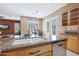 Kitchen island with a double sink and granite countertop at 18009 W Denton Ave, Litchfield Park, AZ 85340