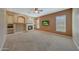 Spacious living room featuring a fireplace, media center, neutral colors and plush carpeting at 18009 W Denton Ave, Litchfield Park, AZ 85340