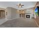 Spacious living room with a fireplace, a ceiling fan, and neutral-toned walls with recessed lighting at 18009 W Denton Ave, Litchfield Park, AZ 85340