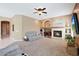 Spacious living room featuring a fireplace and built-in shelving at 18009 W Denton Ave, Litchfield Park, AZ 85340