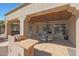 Covered patio with seating area and built-in BBQ at 18009 W Denton Ave, Litchfield Park, AZ 85340