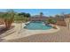 Inviting backyard pool area with a waterfall feature, surrounded by lush landscaping and comfortable lounge chairs at 18009 W Denton Ave, Litchfield Park, AZ 85340