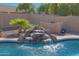 Stunning waterfall feature adjacent to the pool at 18009 W Denton Ave, Litchfield Park, AZ 85340