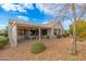 House exterior showcasing backyard patio and landscaping at 18135 N Saddle Ridge Dr, Surprise, AZ 85374