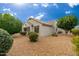 House exterior showcasing backyard landscaping and rock at 18135 N Saddle Ridge Dr, Surprise, AZ 85374