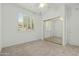 Well-lit bedroom with mirrored closet doors at 18135 N Saddle Ridge Dr, Surprise, AZ 85374