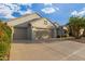 Two-car garage home with drought-tolerant landscaping and a paved driveway at 18135 N Saddle Ridge Dr, Surprise, AZ 85374