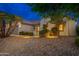 House exterior with walkway, landscaping, and lighting at 18135 N Saddle Ridge Dr, Surprise, AZ 85374