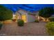 House exterior view at dusk, showcasing landscaping at 18135 N Saddle Ridge Dr, Surprise, AZ 85374