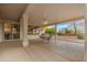 Covered patio with seating area, ceiling fan, and sliding glass door at 18135 N Saddle Ridge Dr, Surprise, AZ 85374