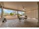 Covered patio with seating area, ceiling fan, and view of the backyard at 18135 N Saddle Ridge Dr, Surprise, AZ 85374