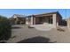 Landscaped backyard with gravel and covered patio at 18171 W Glenhaven Dr, Goodyear, AZ 85338