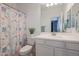 Clean bathroom with white vanity and seashell shower curtain at 18171 W Glenhaven Dr, Goodyear, AZ 85338