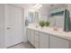 Double vanity bathroom with white cabinets and a large mirror at 18171 W Glenhaven Dr, Goodyear, AZ 85338