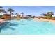 Relaxing freeform community pool with surrounding landscaping at 18171 W Glenhaven Dr, Goodyear, AZ 85338