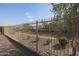 Ornate metal fence with desert landscaping at 18171 W Glenhaven Dr, Goodyear, AZ 85338