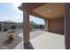 Covered patio with stone pavers and desert landscaping at 18171 W Glenhaven Dr, Goodyear, AZ 85338