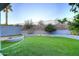 Artificial turf backyard with mature trees and retaining wall at 18258 N 15Th Pl, Phoenix, AZ 85022