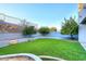 Landscaped backyard with artificial turf and mature trees at 18258 N 15Th Pl, Phoenix, AZ 85022