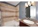 Bathroom with granite countertop, tiled shower/tub, and neutral palette at 18258 N 15Th Pl, Phoenix, AZ 85022