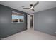 Bedroom with window view, ceiling fan, and neutral wall tones at 18258 N 15Th Pl, Phoenix, AZ 85022