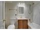 Bathroom with a bathtub, wood vanity, and marble tile at 1918 W Colter St, Phoenix, AZ 85015