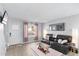 Cozy living room features a leather sofa and wood-look floors at 19601 N 7Th St # 1042, Phoenix, AZ 85024