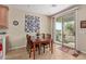 Dining area with wooden table and sliding glass doors at 21532 N 262Nd Ln, Buckeye, AZ 85396