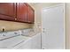 Convenient laundry room with washer, dryer, and cabinets at 21918 N 66Th Ln, Glendale, AZ 85310