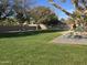 Park-like setting with grassy area, picnic table, and playground at 21918 N 66Th Ln, Glendale, AZ 85310