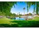 Serene pond with waterfall feature and lush landscaping at 21918 N 66Th Ln, Glendale, AZ 85310