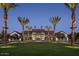 Night view of community clubhouse with palm trees and manicured lawn at 2224 W Chisum Trl, Phoenix, AZ 85085