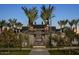 Night view of the community entrance, featuring palm trees and elegant architecture at 2224 W Chisum Trl, Phoenix, AZ 85085