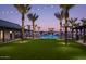 Evening view of community pool area with string lights and palm trees at 2224 W Chisum Trl, Phoenix, AZ 85085