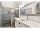 Modern bathroom with a walk-in shower, quartz countertop, and white sink at 2250 E Deer Valley Rd # 77, Phoenix, AZ 85024