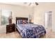 Comfortable bedroom with ensuite bathroom, ceiling fan and ample natural light at 22708 N Kennedy Dr, Maricopa, AZ 85138