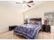 Spacious bedroom with tiled floors, ceiling fan, and ensuite bathroom access at 22708 N Kennedy Dr, Maricopa, AZ 85138