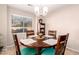 Dining area with wood table and teal chairs at 22708 N Kennedy Dr, Maricopa, AZ 85138