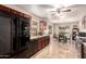 Kitchen with dark wood cabinets and black appliances at 22708 N Kennedy Dr, Maricopa, AZ 85138