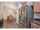 Kitchen with stainless steel refrigerator and an adjacent dining area at 23677 N Desert Dr, Florence, AZ 85132