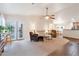 Bright and spacious living room with comfortable seating and a view of the kitchen at 23677 N Desert Dr, Florence, AZ 85132