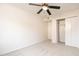 Bright bedroom with ceiling fan, carpet, and double-door closet at 249 E Grandview St, Mesa, AZ 85201