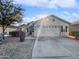 Single-story home with a two-car garage and desert landscaping at 2635 E Desert Wind Dr, Casa Grande, AZ 85194