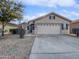 Single story home with a two car garage and desert landscaping at 2635 E Desert Wind Dr, Casa Grande, AZ 85194