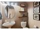 Stylish powder room with an oval mirror and floating shelves at 2769 E Cedar Pl, Chandler, AZ 85249