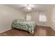 Spacious bedroom with a ceiling fan and leafy bedding at 2881 W Cactus Wren St, Apache Junction, AZ 85120